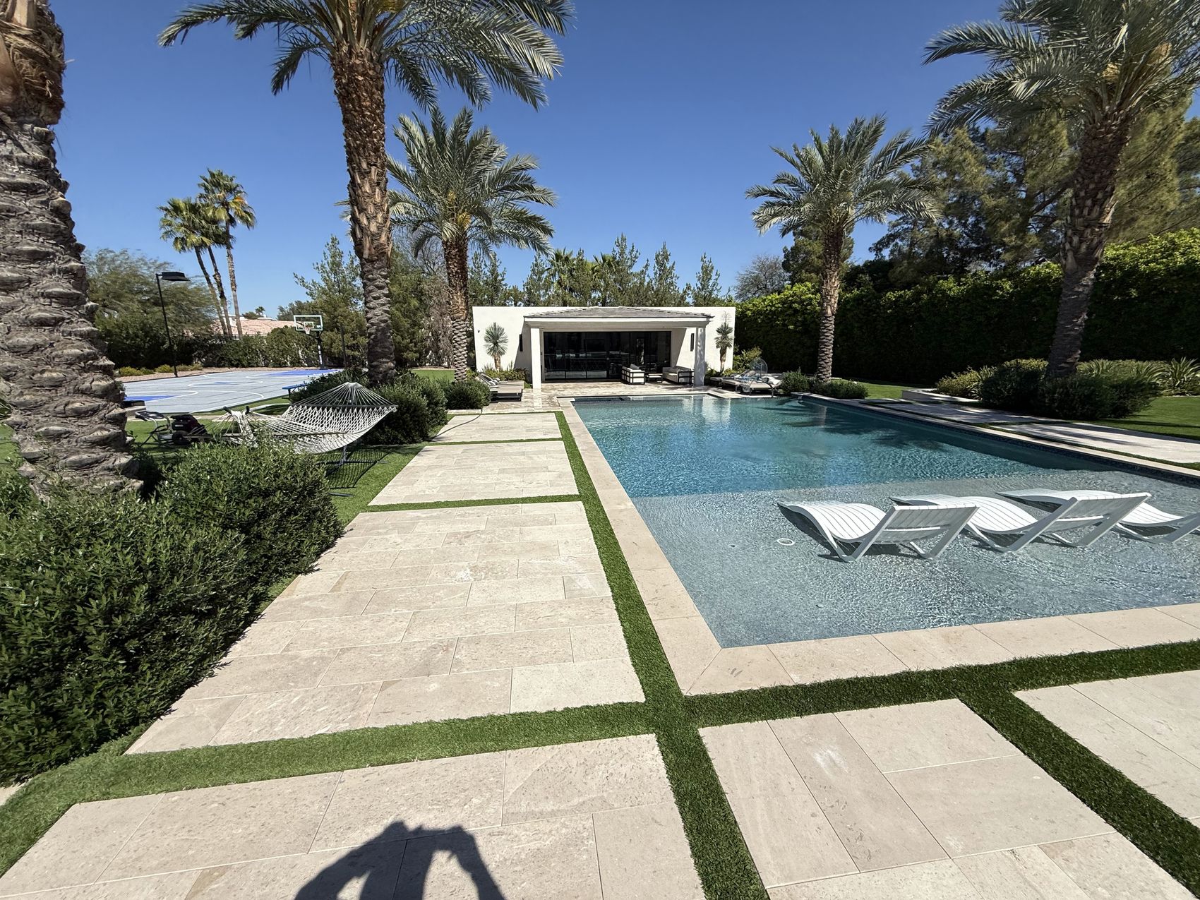 Pristine travertine pool deck cleaned by Apex Power Washing in Queen Creek, Arizona